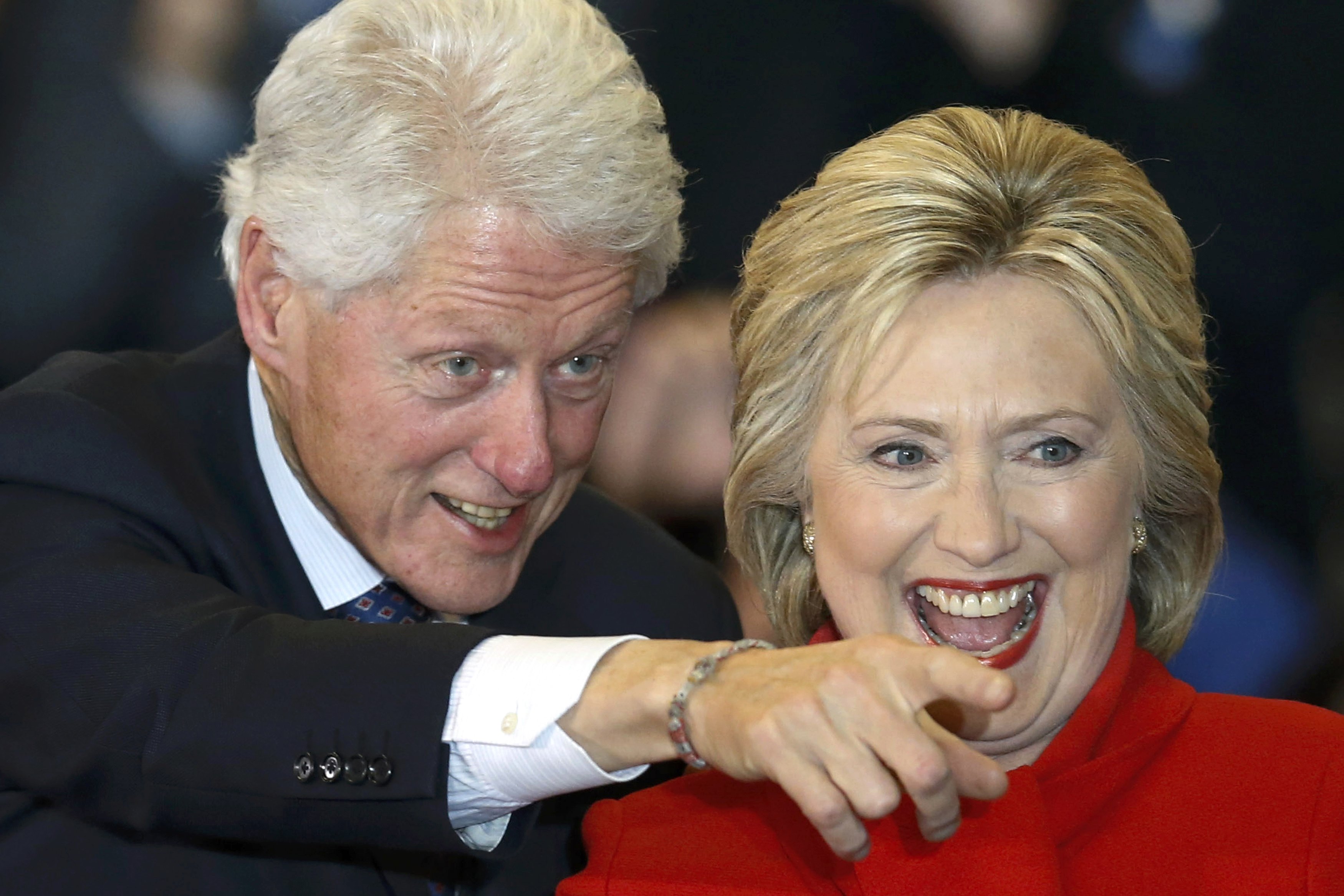 Democratic U.S. presidential candidate Hillary Clinton laughs as she celebrates with her husband, former President Bill Clinton, at a caucus rally in Des Moines, Iowa, on Monday. | REUTERS