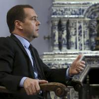 Russian Prime Minister Dmitry Medvedev speaks during an interview at the Gorki state residence outside Moscow Thursday. Medvedev raised the spectre of a permanent or a world war if powers failed to negotiate an end to the conflict in Syria and warned against any ground operations by U.S. and Arab forces. | EKATERINA SHTUKINA / SPUTNIK / POOL / REUTERS