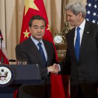 U.S. Secretary of State John Kerry (right) and Chinese Foreign Minister Wang Yi hold a press conference at the State Department in Washington, D.C., Tuesday, after the two sides made progress toward agreeing on a United Nations sanctions resolution to punish North Korea for its recent nuclear tests, the powers\' top diplomats said. An agreement was reached Wednesday, envoys said. | AFP-JIJI