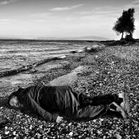 This Jan. 25 image provided by the India Today news magazine shows Chinese artist and activist Ai Weiwei posing as he lies face down on the beach on the Greek island of Lesbos. Chinese artist Ai Weiwei has re-created the famous image of a 3-year-old Syrian child who drowned in Turkey last year by staging a photo of himself lying face down. Activist artist poses as drowned Syrian boy as empathy over refugees' plight ebbs