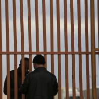 A man makes enquires regarding the opening of the closed Turkish border crossing with Syria, on the outskirts of the town of Kilis, in southeastern Turkey, on Sunday. | AP