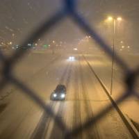 Motorists travel east on West Dodge Road during a snowstorm Tuesday in Omaha, Nebraska. | BRENDAN SULLIVAN / OMAHA WORLD-HERALD VIA AP
