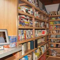 A photo of Yasuhiro Kitagawa, a reporter who died in the deadly 2011 earthquake in Christchurch, New Zealand, is placed Friday in a small library his father opened in his honor in his backyard in Hakusan, Ishikawa Prefecture. | KYODO