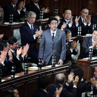 Shinzo Abe is applauded by a group of male colleagues after being elected prime minister in the Lower House in December 2012. Women are extremely underrepresented in Japan politics, where only 11.5 percent of all Diet members are female.  | BLOOMBERG