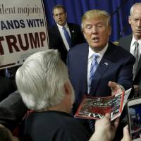 U.S. Republican presidential candidate Donald Trump greets attendees at a campaign event in Iowa on Jan. 24. | REUTERS