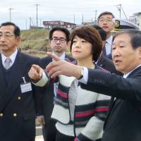 Aiko Shimajiri, minister in charge of pushing for the return of four Russian-held islands off Hokkaido, visits the town of Rausu in eastern Hokkaido in November to view Kunashiri, one of the four islands. | KYODO