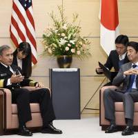 U.S. Navy Adm. Harry B. Harris Jr., commander of the United States Pacific Command, talks with Prime Minister Shinzo Abe during a meeting at the Prime Minister\'s Office on Tuesday. | AP