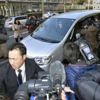 A police vehicle carrying disgraced former slugger Kazuhiro Kiyohara exits the Metropolitan Police Department headquarters in Tokyo last Thursday. | REUTERS
