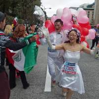 Runners dressed as newlyweds enjoy the festive spirit of the Tokyo Marathon in 2014, in this image shot by fellow competitor Ikuo Tatsumi. The race is so oversubscribed that only 10 percent of amateur runners who apply secure a place. | IKUO TATSUMI