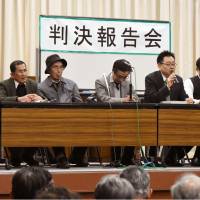 People involved in a lawsuit over the recognition of Nagasaki atomic-bomb survivors hold a news conference Monday after the Nagasaki District Court ordered authorities to recognize 10 people as A-bomb survivors based on new criteria. | KYODO