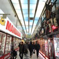 Visitors browse specialty shops selling pop subculture items at Nakano Broadway. | YOSHIAKI MIURA