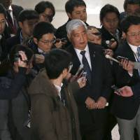 Defense chief Gen Nakatani is questioned by reporters upon arrival at the Defense Ministry in Tokyo on Sunday. | REUTERS