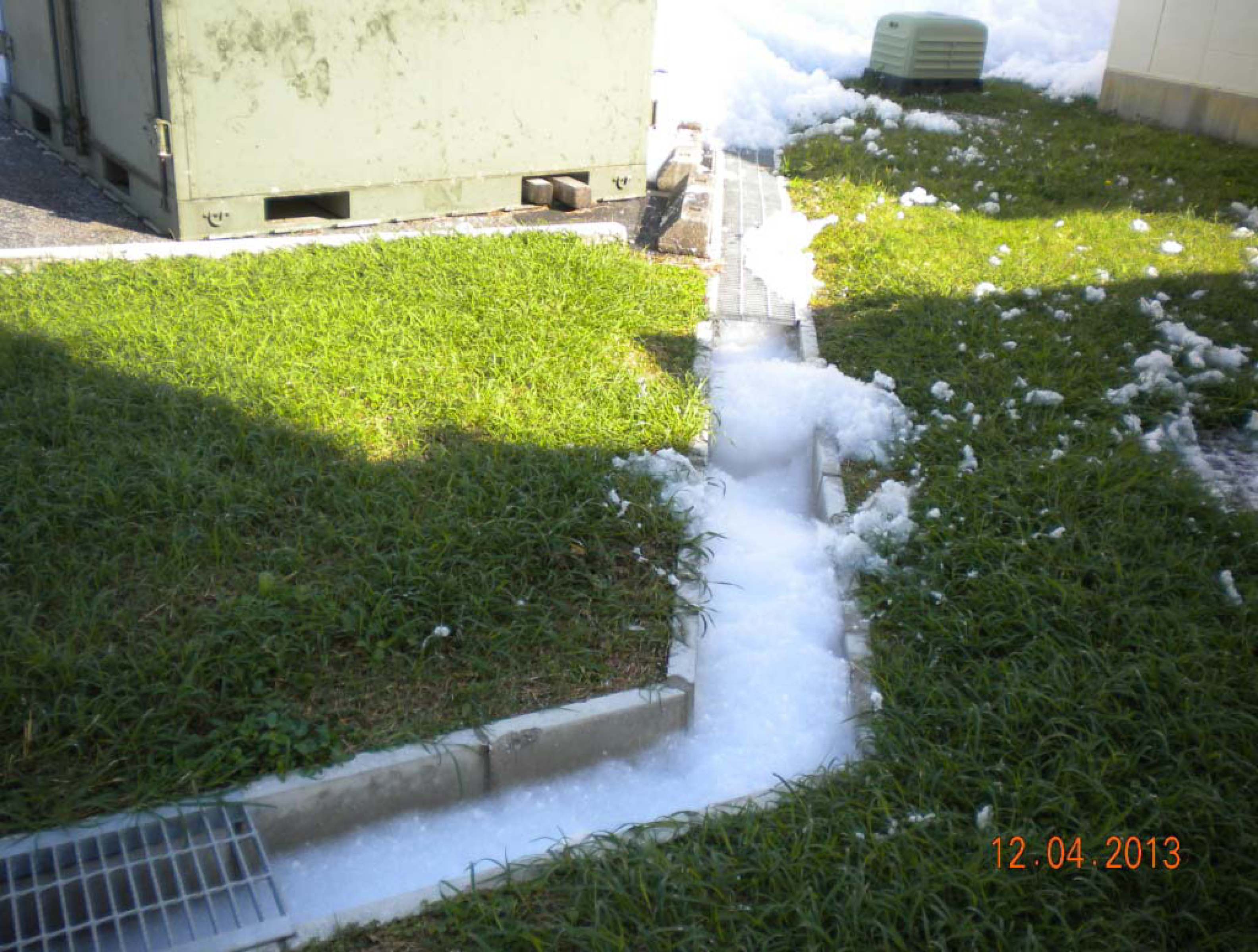 A fire extinguishing agent is washed out in a storm drain at Kadena Air Base in Okinawa Prefecture on Dec. 4, 2013, in a photo obtained through the U.S. Freedom of Information Act. | JON MITCHELL