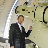 Amateur astronomer Masakatsu Aoki poses in front of his observatory in the city of Toyama on Feb. 12. | KYODO