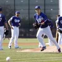 Dodgers pitcher Kenta Maeda participates in fielding practice on Saturday in Glendale, Arizona. | KYODO