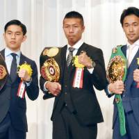 World champions Takashi Uchiyama (center), Kazuto Ioka (left) and  Shinsuke Yamanaka on Friday received awards in recogntion of their accomplishments as top Japanese boxers in 2015. | KYODO