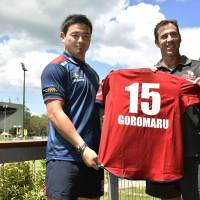 Ayumu Goromaru (left) poses with Queensland Reds coach Richard Graham after being unveiled by the Super Rugby team on Monday. | KYODO