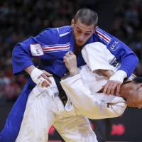 Daiki Nishiyama (bottom) competes with France\'s Alexandre Iddir in the men\'s 90-kg final at the Judo Grand Slam in Paris on Sunday. | REUTERS