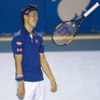 Kei Nishikori tosses his racket in the air during his second-round match with Sam Querrey at the Acapulco Open on Wednesday. Querrey won 6-4, 6-3. | KYODO