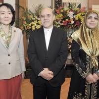 Iran Ambassador Reza Nazar Ahari (center) and his wife Sedigheh (right) welcome Parliamentary Vice-Minister for Foreign Affairs Miki Yamada, during a reception to celebrate the 37th Anniversary of the Islamic Revolution of Iran at the embassy in Tokyo on Feb. 10. | YOSHIAKI MIURA