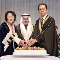 Kuwait Ambassador Abdul Rahman Humood Al-Otaibi (center) cuts a cake with Parliamentary Vice-Minister for Foreign Affairs Miki Yamada (left) and Fukushima Prefecture Gov. Masao Uchibori, during a reception to celebrate the country\'s 55th National Day and the 25th Anniversary of the Liberation of the State of Kuwait at the Palace Hotel, in Tokyo on Feb. 22. | YOSHIAKI MIURA