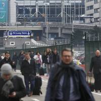 People leave the scene of explosions at Zaventem airport near Brussels on March 22. | REUTERS