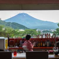 A bar in a hotel near Lake Kawaguchi in Yamanashi Prefecture provides a scenic view of Mount Fuji. | BLOOMBERG