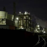 Smoke rises from factories at the Keihin industrial zone in Kawasaki, Kanagawa Prefecture, on Monday. | REUTERS