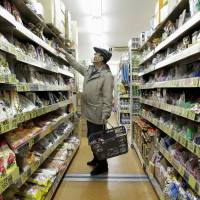 A customer shops at a Sankei Super, K.K. supermarket in Tokyo last month. Household spending dropped for the fifth straight month in January, the government said Tuesday. | BLOOMBERG