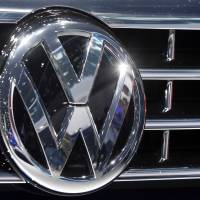 The Volkswagen logo is seen in September on a car during the Car Show in Frankfurt, Germany. Volkswagen deleted documents and obstructed justice after the U.S. Environmental Protection Agency accused the company of cheating on emissions tests, a former employee alleges in a lawsuit. | AP