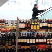 A shelf displaying bottles of wine inside a branch of Marks & Spencer in London on March 2. The European Union maintains Japan\'s smaller wine bottles would allow Japanese sellers to undercut prices. | BLOOMBERG