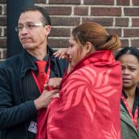 People comfort each other after being evacuated from Brussels airport, after explosions rocked the facility  on Tuesday morning. | REUTERS