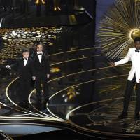 Oscars host Chris Rock gestures to Asian-American boys portraying auditors in a skit on Feb. 28 at the Dolby Theater in Los Angeles. Asian-American jab at Oscars reveals deeper diversity woes