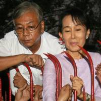 Htin Kyaw stands with Aung San Suu Kyi at her residence in Yangon on Nov. 13, 2010, the day of her release from nearly two decades of house arrest. | AFP-JIJI