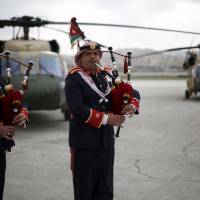 Members of a Jordanian police band perform during a handover ceremony held to deliver Black Hawk helicopters to Jordan from the U.S. government at Amman military airport Thursday. | REUTERS