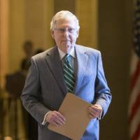Senate Majority Leader Mitch McConnell walks to the chamber just after President Barack Obama urged Senate Republicans to grant hearings and a confirmation vote to Merrick Garland, his nominee to replace the late Justice Antonin Scalia on the Supreme Court, on Capitol Hill in Washington, Wednesday. McConnell has been steadfast in his refusal to hold a confirmation for any nominee during the waning months of Obama\'s presidency. | AP