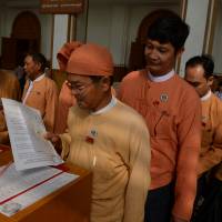 National League for Democracy lawmakers arrive at the Myanmar parliament for the historic presidential vote on Tuesday. It confirmed that Htin Kyaw, a writer and longtime friend of Aung San Suu Kyi, will become the nation\'s first civilian leader in decades. | AFP-JIJI