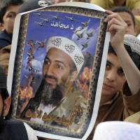 Protesters carry a portrait of slain al-Qaida leader Osama bin Laden at a 2012 anti-U.S. rally in Quetta, Pakistan, on the first anniversary of his death. Bin Laden's will, letters among more than 100 documents released
