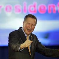 Republican presidential candidate Ohio Gov. John Kasich celebrates before speaking at his presidential primary election rally in Berea, Ohio, on Tuesday. Kasich won Ohio in the primary. | AP