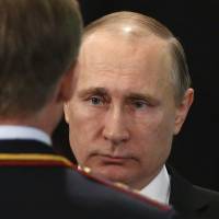 Russian President Vladimir Putin listens to a report during an Interior Ministry meeting in Moscow on Tuesday. Seat at front of geopolitical table allowed Putin to scale back in Syria