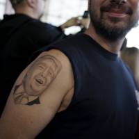 A supporter shows his tattoo before U.S. Republican presidential candidate Donald Trump\'s campaign rally at Winner Aviation in Youngstown, Ohio, Monday. | REUTERS