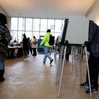 Voters head to the polls to vote on Super Tuesday at Old St. Mary\'s Church in Chicago on Tuesday. Americans in five states voted Tuesday in presidential primaries crucial to the White House hopes of front-runners Donald Trump and Hillary Clinton but that have also showcased the deep-seated discontent of a downtrodden working class. | AFP-JIJI