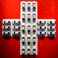 Model white cars sits in a cross formation of the Swiss national flag on the second day of the 86th Geneva International Motor Show in  Switzerland on Wednesday. The show opened to the public on March 3. | BLOOMBERG
