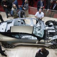Journalists pore over a cut-down Aston Martin on the second press day of the 86th International Auto Show in Geneva on Wednesday. The show opened to the public on Thursday and runs until March 13. It has more than 200 exhibitors, and more than 120 product launches are expected. | MARTIAL TREZZINI, KEYSTONE / AP