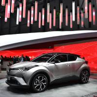 Visitors look at a Toyota C-HR Coupe High Rider at the stand of Japanese carmaker during the press day of the Geneva Motor Show. | AFP-JIJI