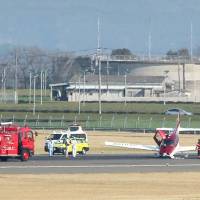 A damaged plane clogs up the middle of Kagoshima Airport\'s sole runway in Kirishima, Kagoshima Prefecture, on Monday. | KYODO
