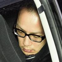 Takahiro Tokura, suspected of killing a 25-year-old woman last year in the capital, enters the Metropolitan Police Department on Saturday in Tokyo. | KYODO