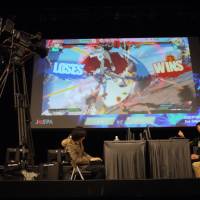 Dogura (right) wins Japan\'s first nationwide competitive video gaming tournament on March 13, as the game is broadcast live online. | DAISUKE KIKUCHI