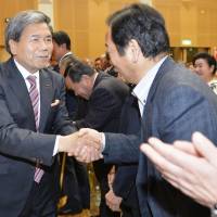 Incumbent Kumamoto Gov. Ikuo Kabashima celebrates his victory in a gubernatorial election Sunday in the city of Kumamoto. | KYODO