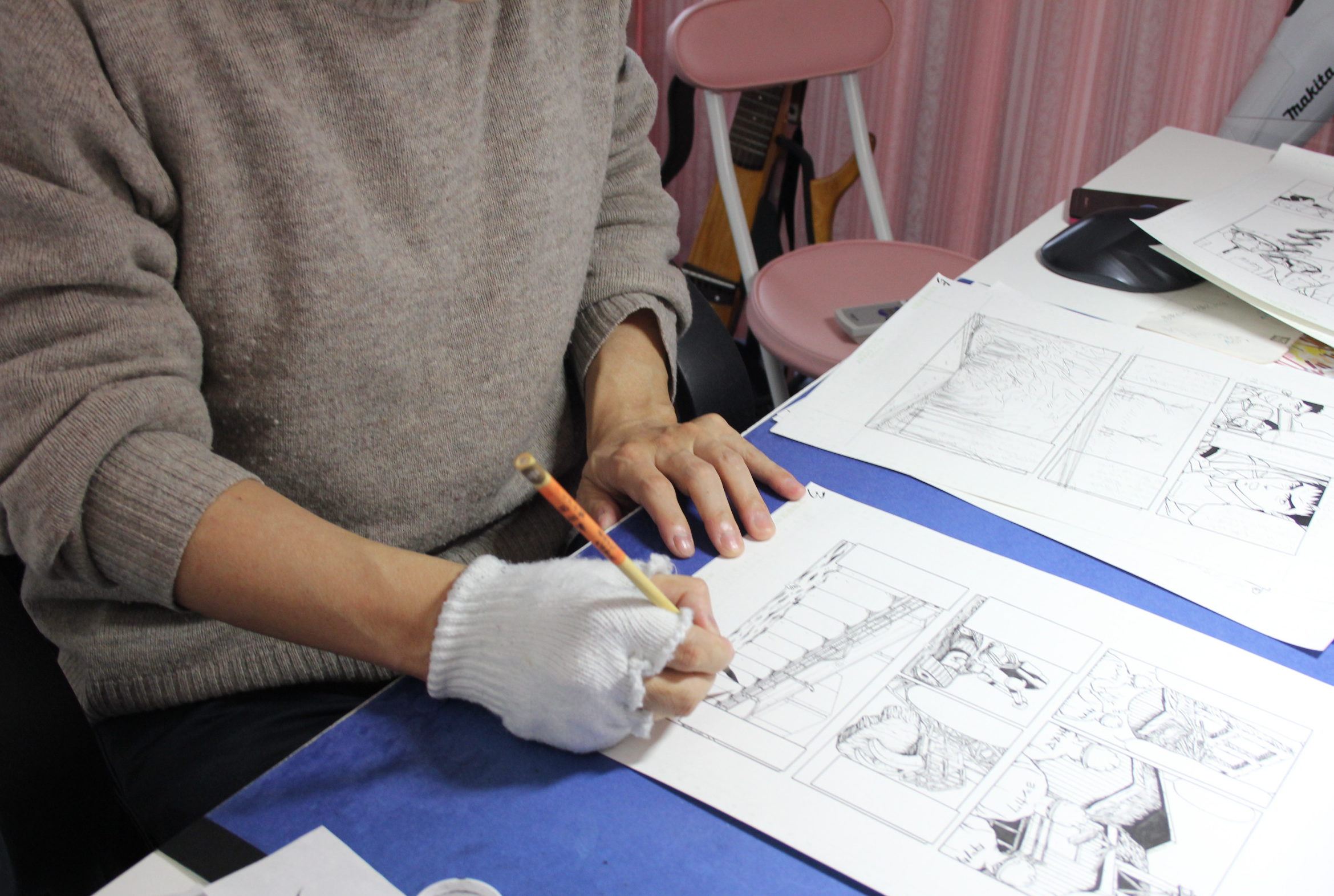 Kazuto Tatsuta, who has been involved in decommissioning work at the Fukushima No. 1 nuclear plant, works on a new manga story at his office in a Tokyo suburb on Feb. 16. | KYODO